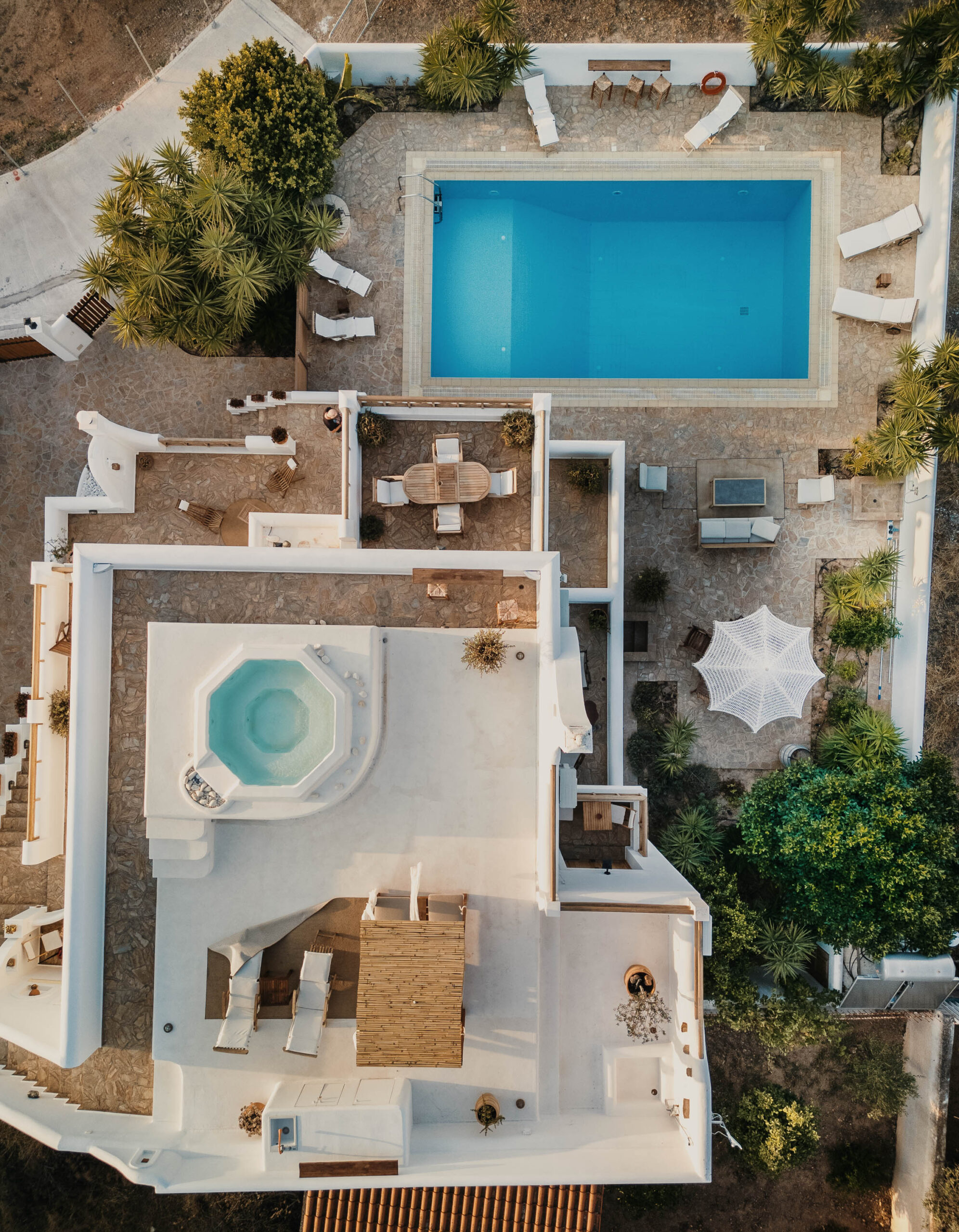 Villa Kyma seen from above: pool, outdoor dining, rooftop jacuzzi and roof terrace