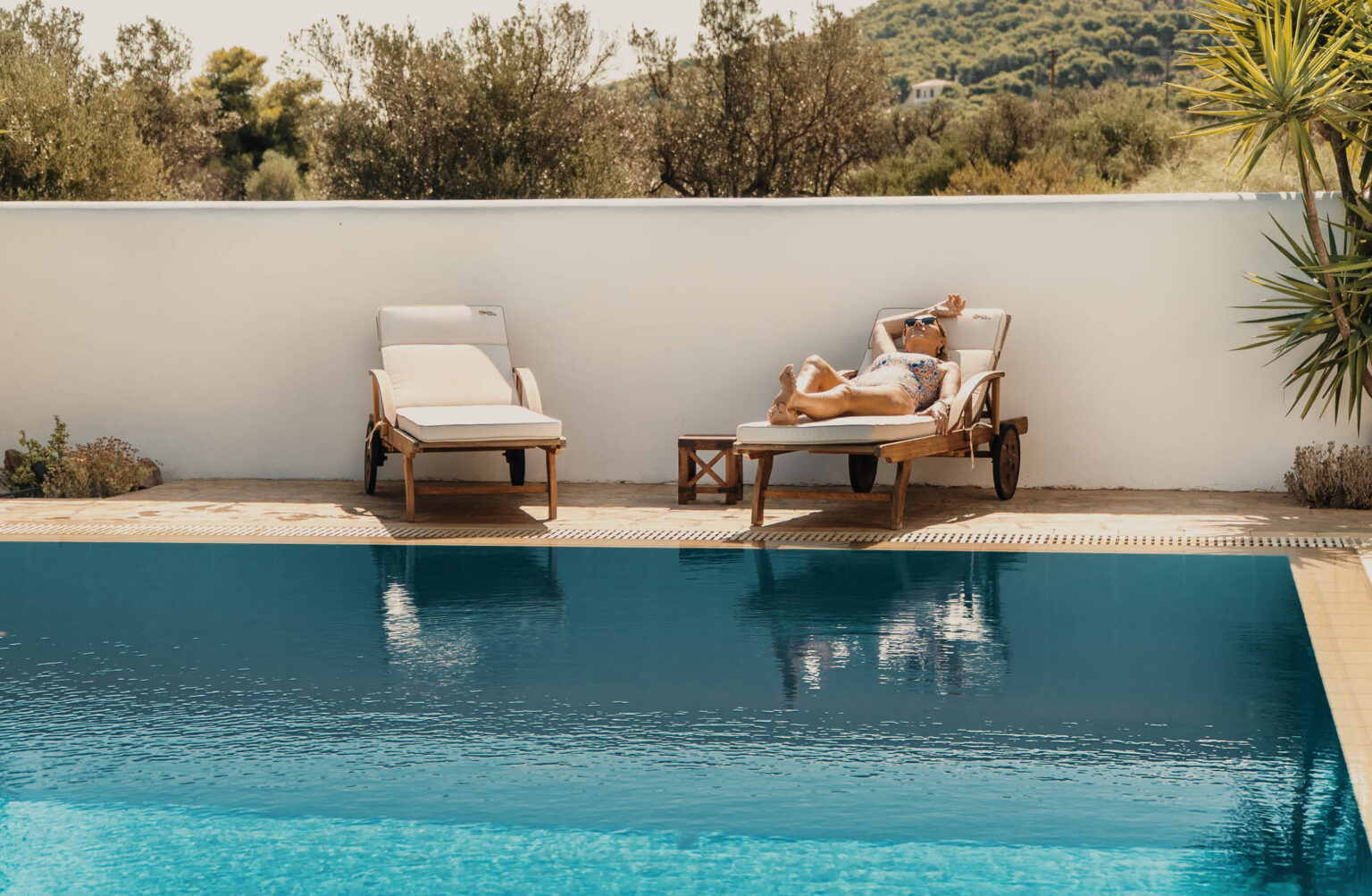 Sun loungers by the pool at Villa Kyma